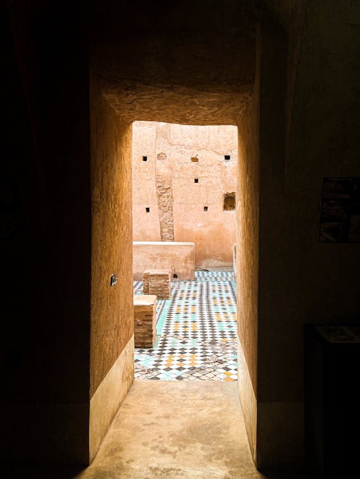 A view through a doorway into a vibrant Moroccan courtyard in Marrakech, Morocco.