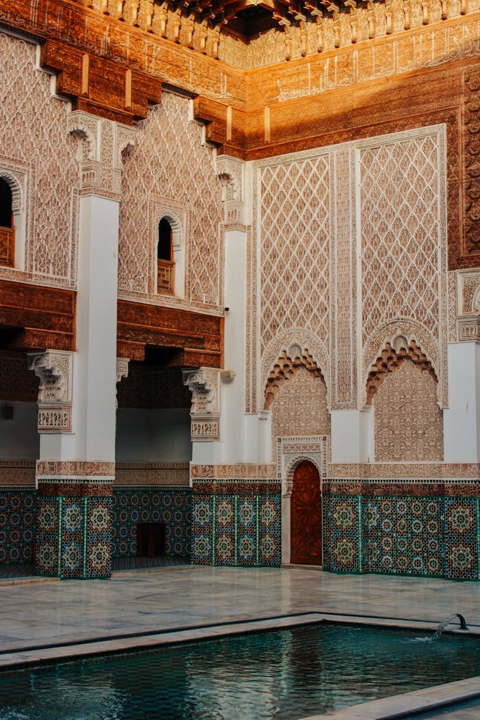 Intricate Islamic architecture of a historic madrasa in Marrakech, showcasing Moroccan tilework and carvings.