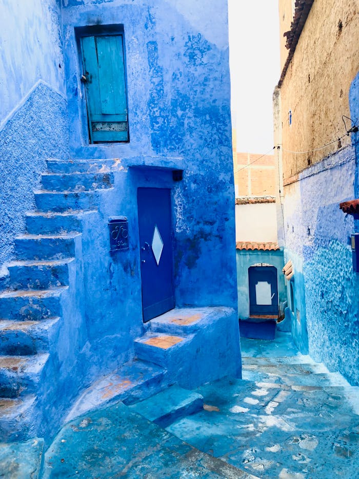 Explore the iconic blue alleyways of Chefchaouen, Morocco, capturing its vibrant and unique architecture.